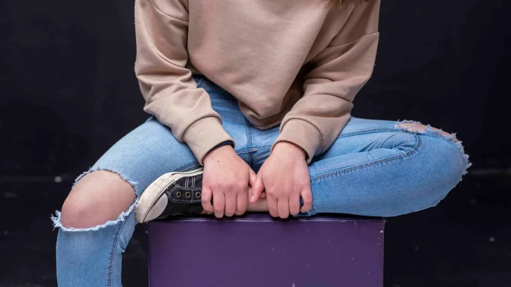 Woman in a casual sweatshirt and jeans inspiring Bible verse sweatshirt outfit ideas