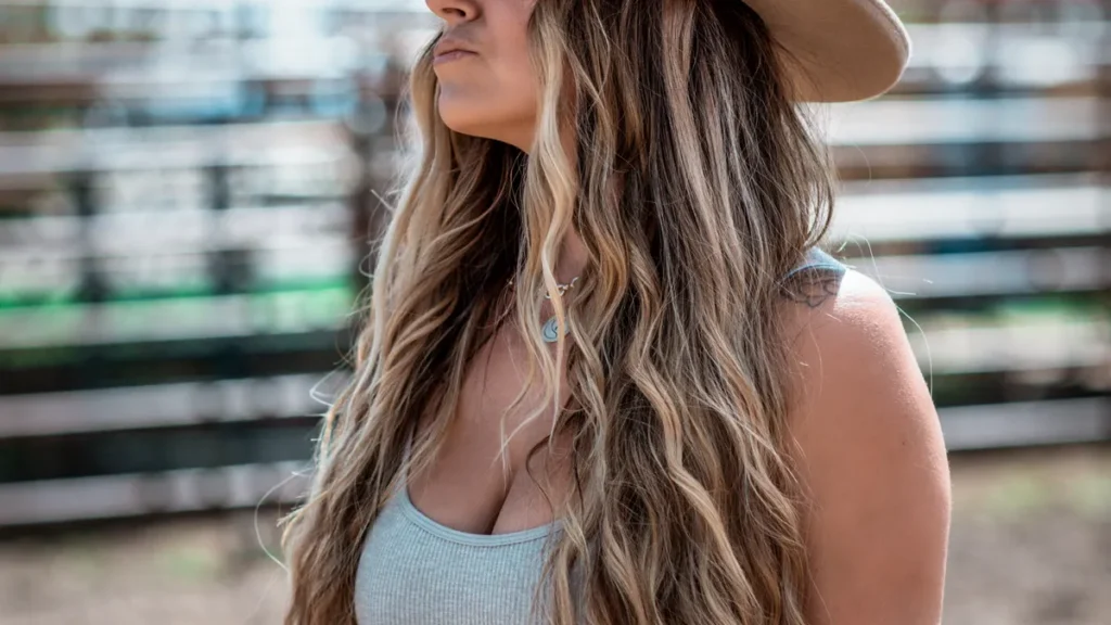 Woman in a dark cowboy hat inspiring casual ghost cowgirl outfit ideas