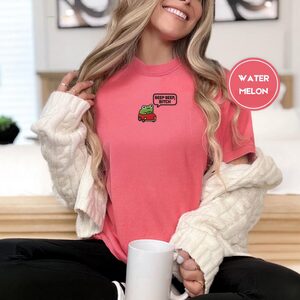 Person wearing a watermelon Beep Beep Driving Frog Embroidered T-Shirt