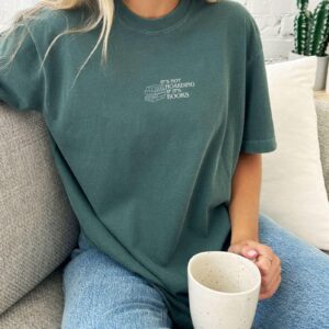 Person wearing a blue spruce Book Hoarding Embroidered T-Shirt