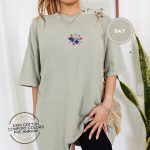 Person wearing a bay Books and Flowers Embroidered T-Shirt