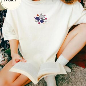 Person wearing an ivory Books and Flowers Embroidered T-Shirt