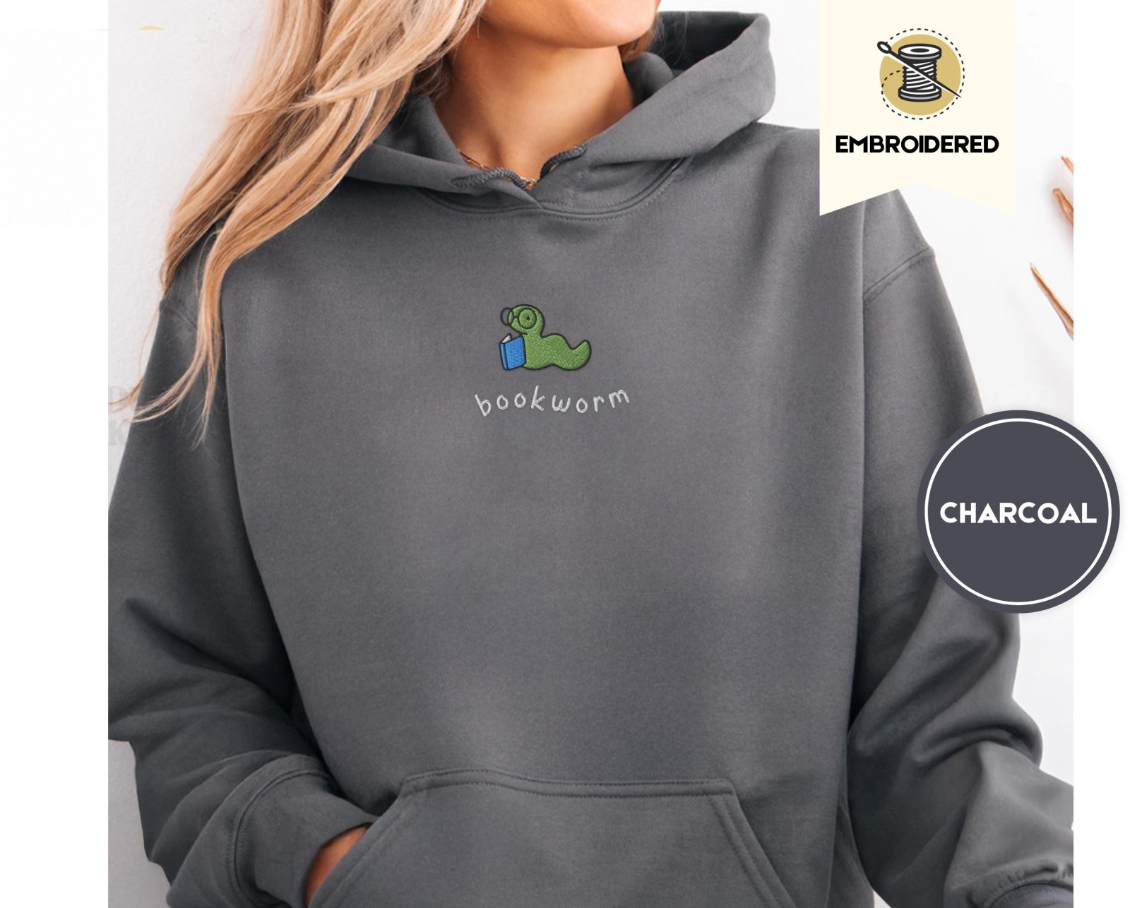 Person wearing a charcoal Bookworm Embroidered Hoodie