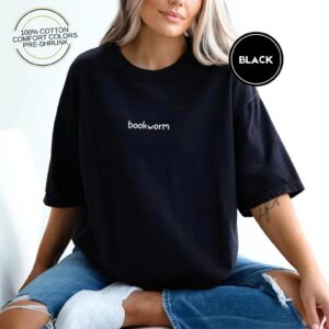 Person wearing a black Bookworm Embroidered T-Shirt