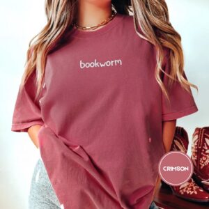 Person wearing a crimson Bookworm Embroidered T-Shirt