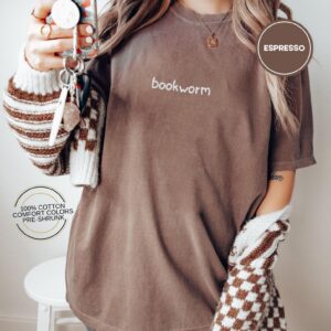 Person wearing an espresso Bookworm Embroidered T-Shirt