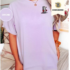 Person wearing an orchid Boxing Possum Embroidered T-Shirt