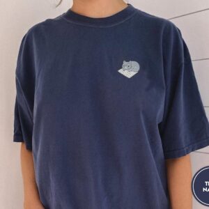 Person wearing a true navy Cat on Open Book Embroidered T-Shirt