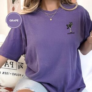 Person wearing a grape Catini Martini Cat Embroidered T-Shirt