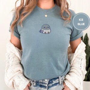 Person wearing an ice blue Chubby Pigeon Embroidered T-Shirt