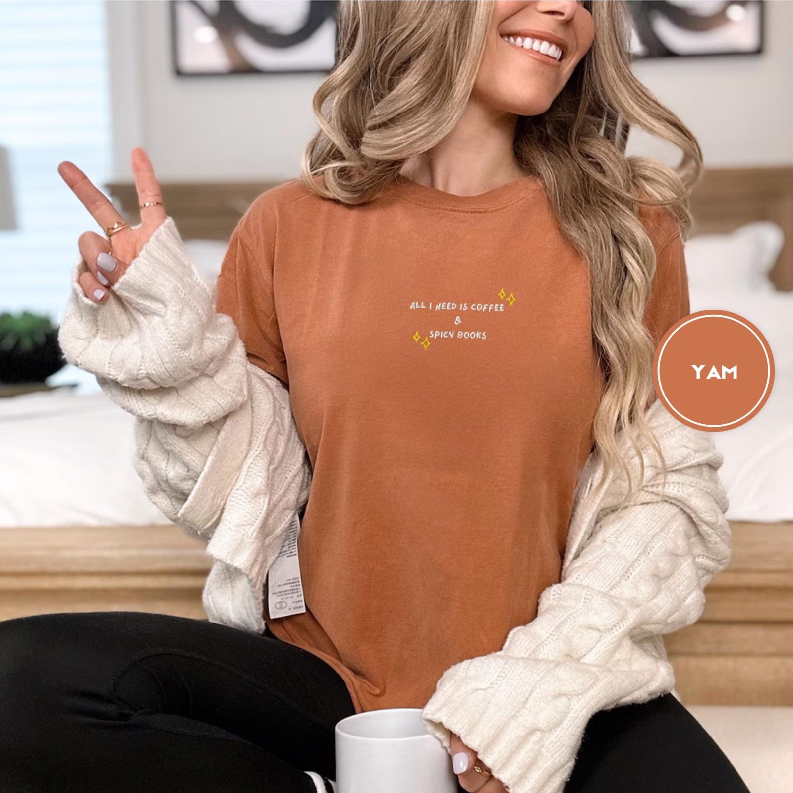 Person wearing a yam Coffee And Spicy Books Embroidered T-Shirt