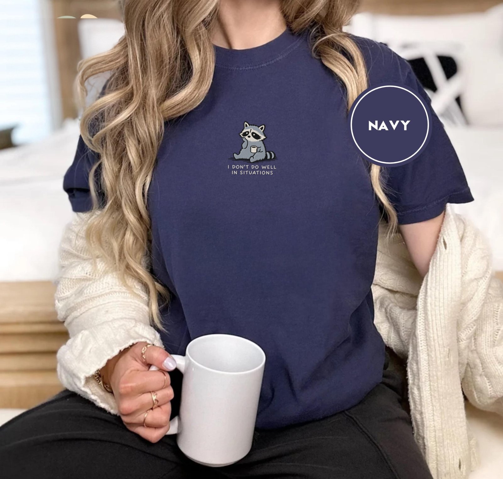 Person wearing a navy Coffee Cup Raccoon Embroidered T-Shirt