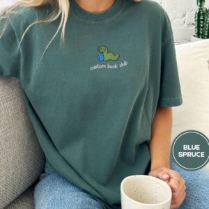 Person wearing a blue spruce Custom Book Club Bookworm Embroidered T-Shirt
