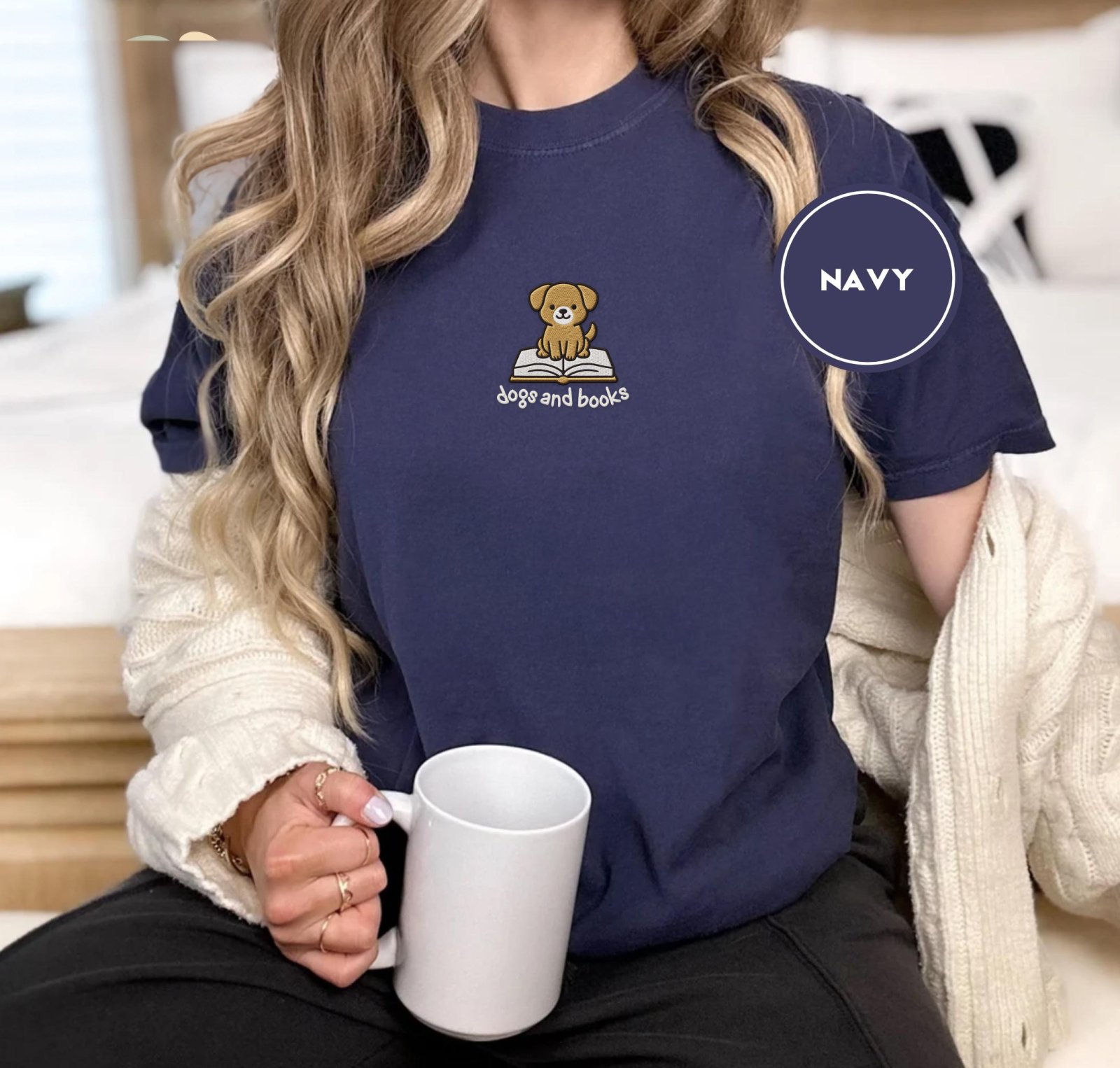 Person wearing a navy Dogs and Books Embroidered T-Shirt