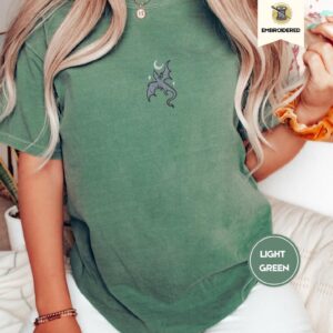 Person wearing a light green Dragon and Crescent Moon Embroidered T-Shirt