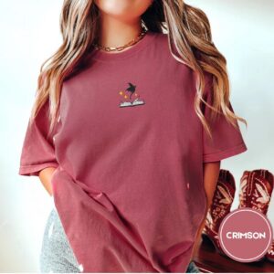 Person wearing a crimson Dragon and Open Book Embroidered T-Shirt