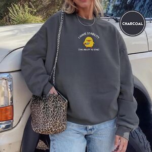 Person wearing a charcoal Duck With Knife Embroidered Sweatshirt