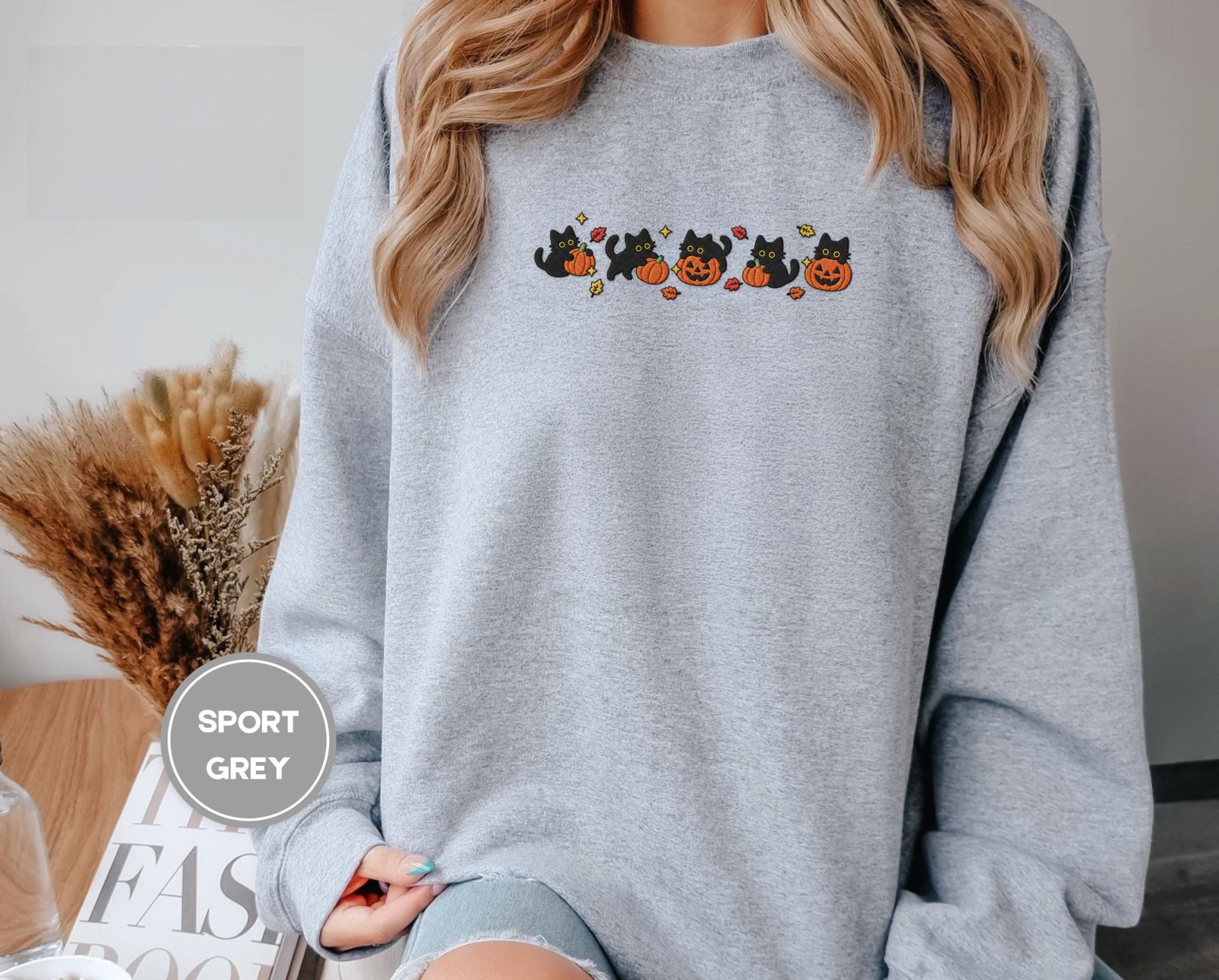 Person wearing a sport grey Five Cat Pumpkin Parade Embroidered Sweatshirt