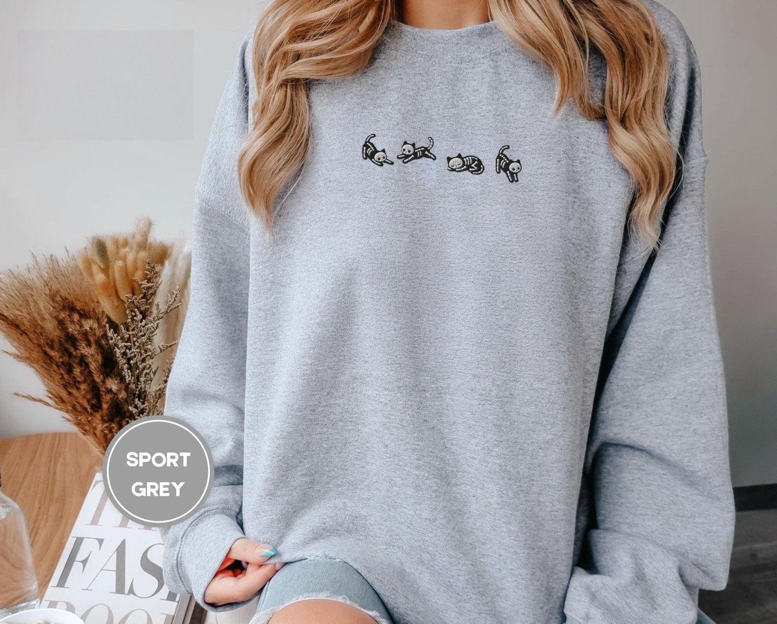 Person wearing a sport grey Five Posing Skeleton Cats Embroidered Sweatshirt