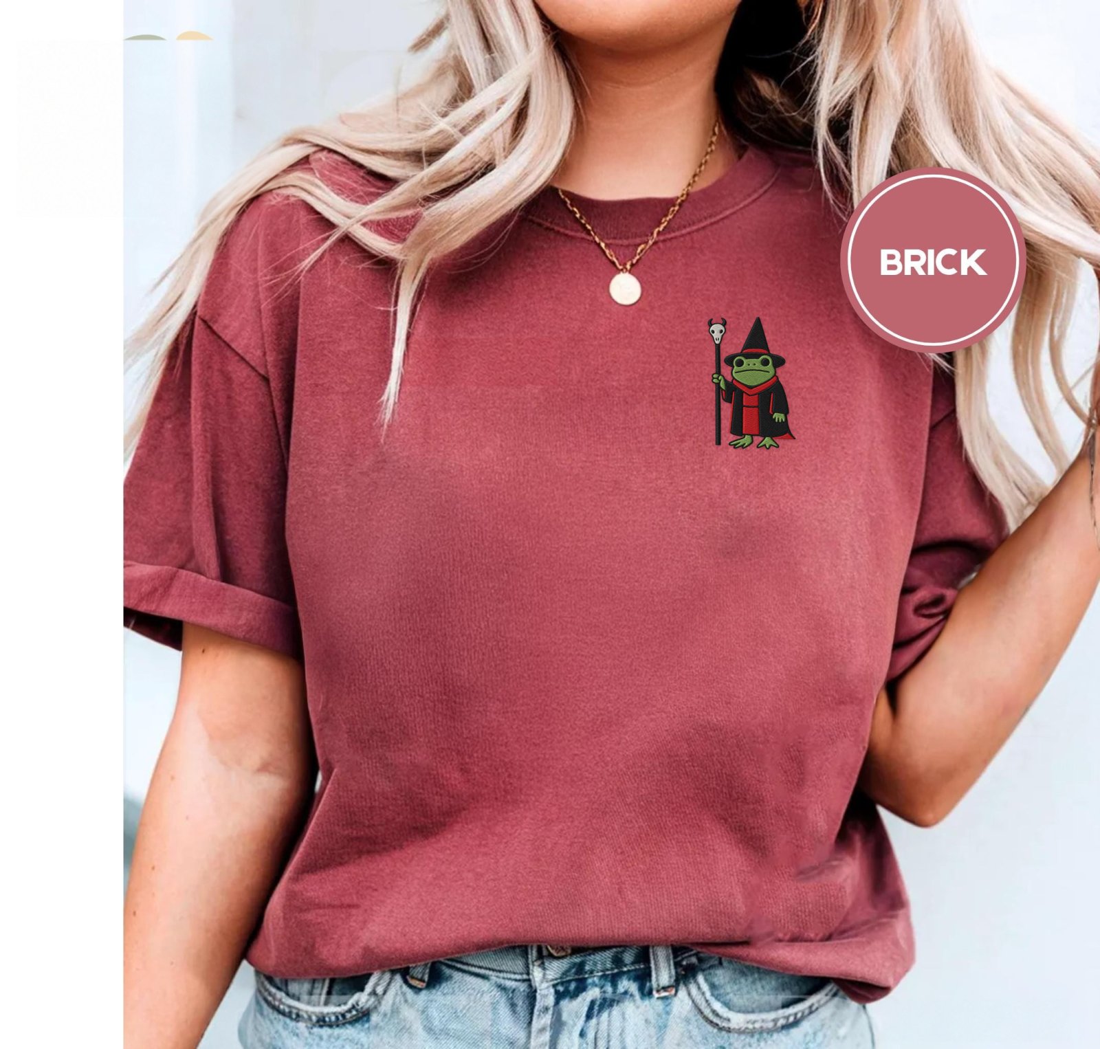 Person wearing a brick Frog and Skull Staff Embroidered T-Shirt