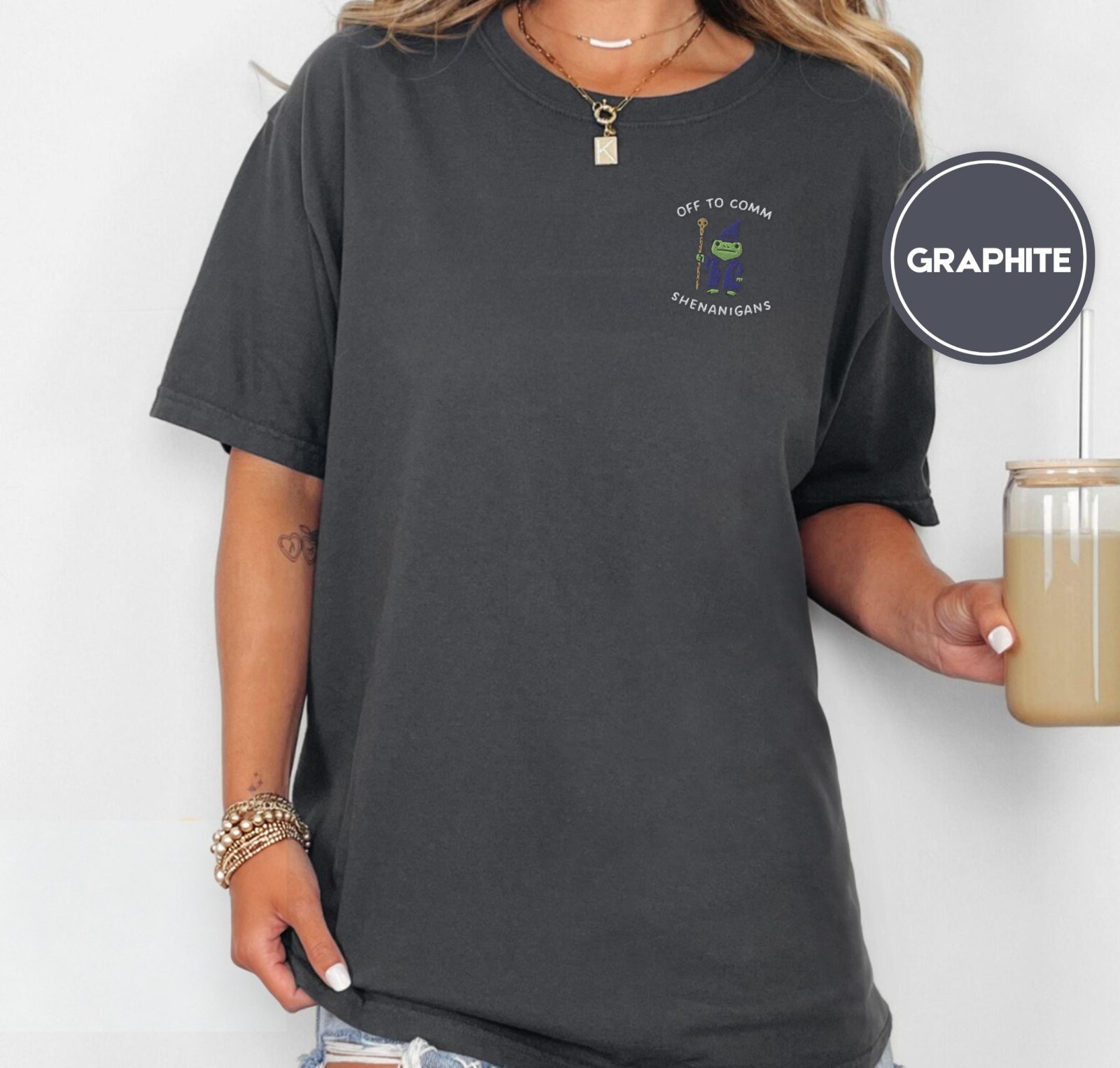 Person wearing a graphite Frog Wizard Shenanigans Embroidered T-Shirt