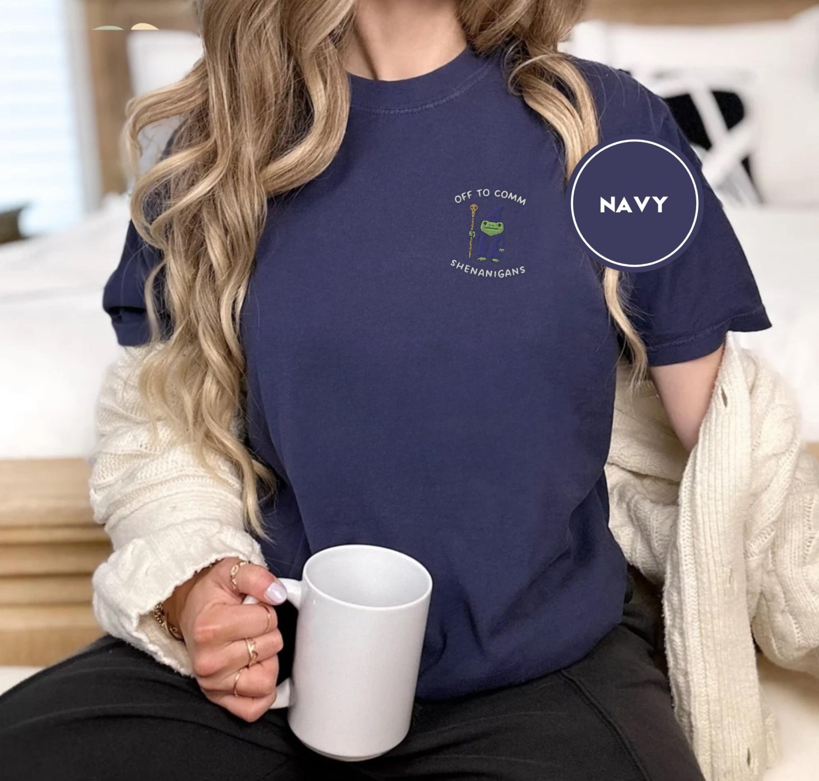 Person wearing a navy Frog Wizard Shenanigans Embroidered T-Shirt