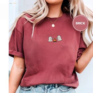 Person wearing a brick Ghost Campfire Embroidered T-Shirt