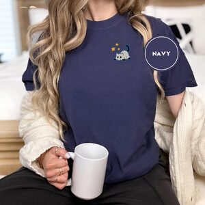 Person wearing a navy Ghost Cat and Stars Embroidered T-Shirt