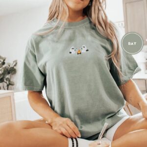 Person wearing a bay Ghosts Roasting Marshmallows Embroidered T-Shirt
