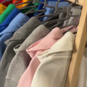 Video of Gildan hoodies in many colors on a clothing rack