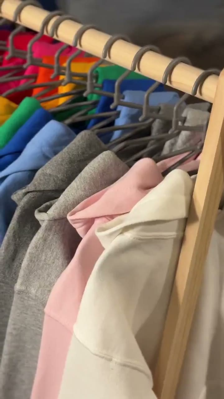 Video of Gildan hoodies in many colors on a clothing rack