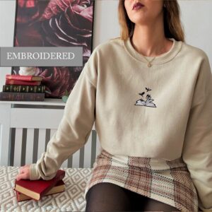 Person wearing a sand Gold Sparkle Dragons Embroidered Sweatshirt