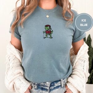 Person wearing an ice blue Golfing Frog Embroidered T-Shirt