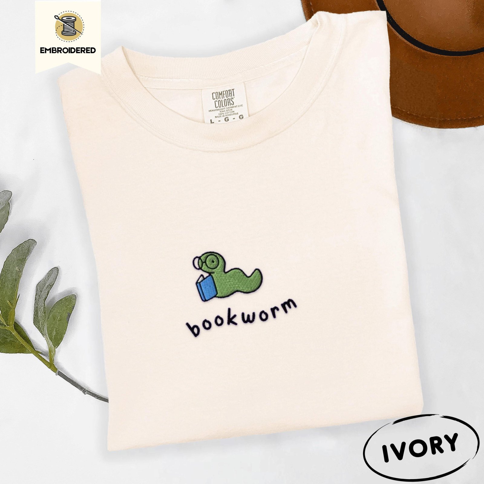 Ivory Green Bookworm With Blue Book Embroidered T-Shirt
