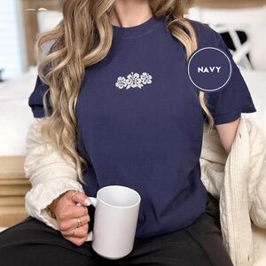 Person wearing a navy Hibiscus Flowers Embroidered T-Shirt