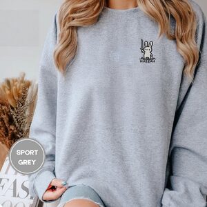 Person wearing a sport grey Huzzah Sword Bunny Embroidered Sweatshirt