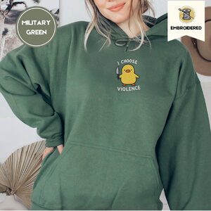 Person wearing a military green I Choose Violence Duck Embroidered Hoodie
