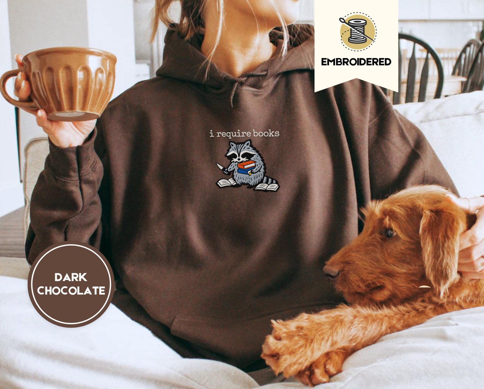 Person wearing a dark chocolate I Require Books Raccoon Embroidered Hoodie