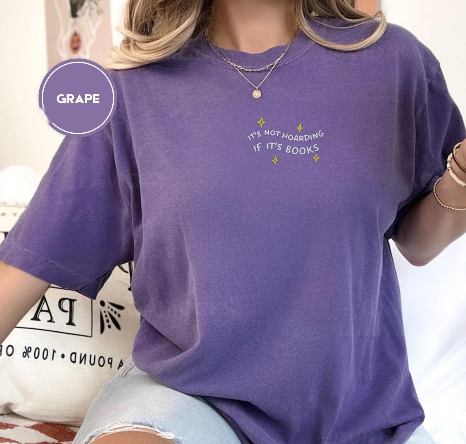 Person wearing a grape It’s Not Hoarding If It’s Books Embroidered T-Shirt