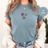 Person wearing an ice blue Ladybug Bee and Leaf Embroidered T-Shirt