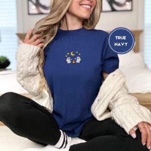 Person wearing a true navy Marshmallow Roasting Ghosts Embroidered T-Shirt