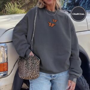 Person wearing a charcoal Monarch Butterfly Duo Embroidered Sweatshirt