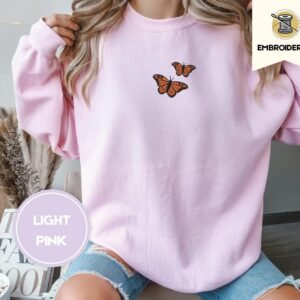 Person wearing a light pink Monarch Butterfly Duo Embroidered Sweatshirt