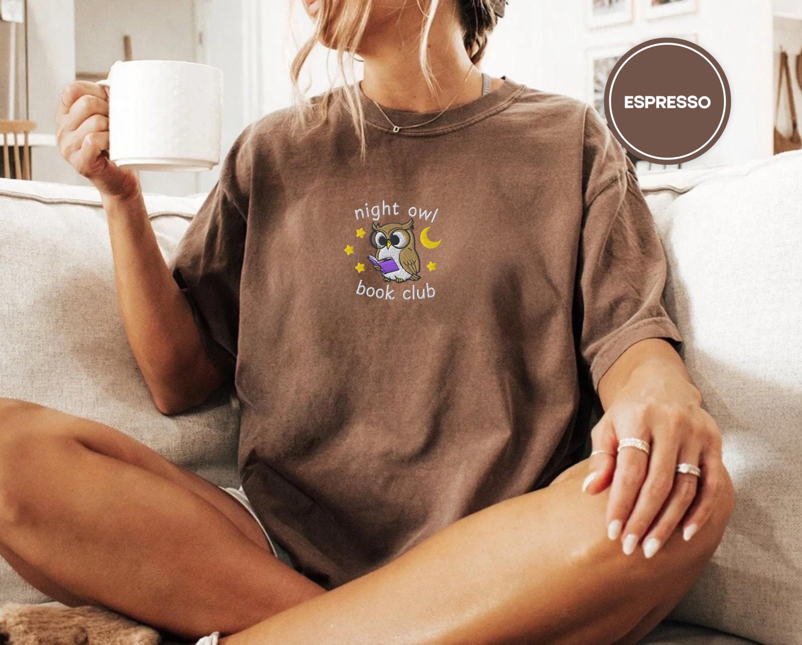 Person wearing an espresso Night Owl Book Club Embroidered T-Shirt