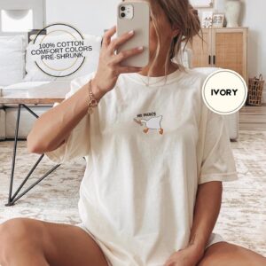 Person wearing an ivory No Mercy Goose Embroidered T-Shirt