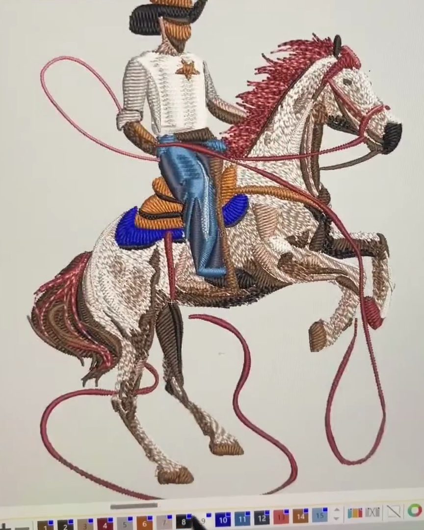 Embroidery software on a computer screen showing a cowboy on a rearing horse, digitized into stitches