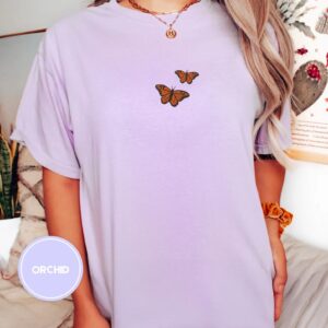 Person wearing an orchid Orange Butterflies Embroidered T-Shirt