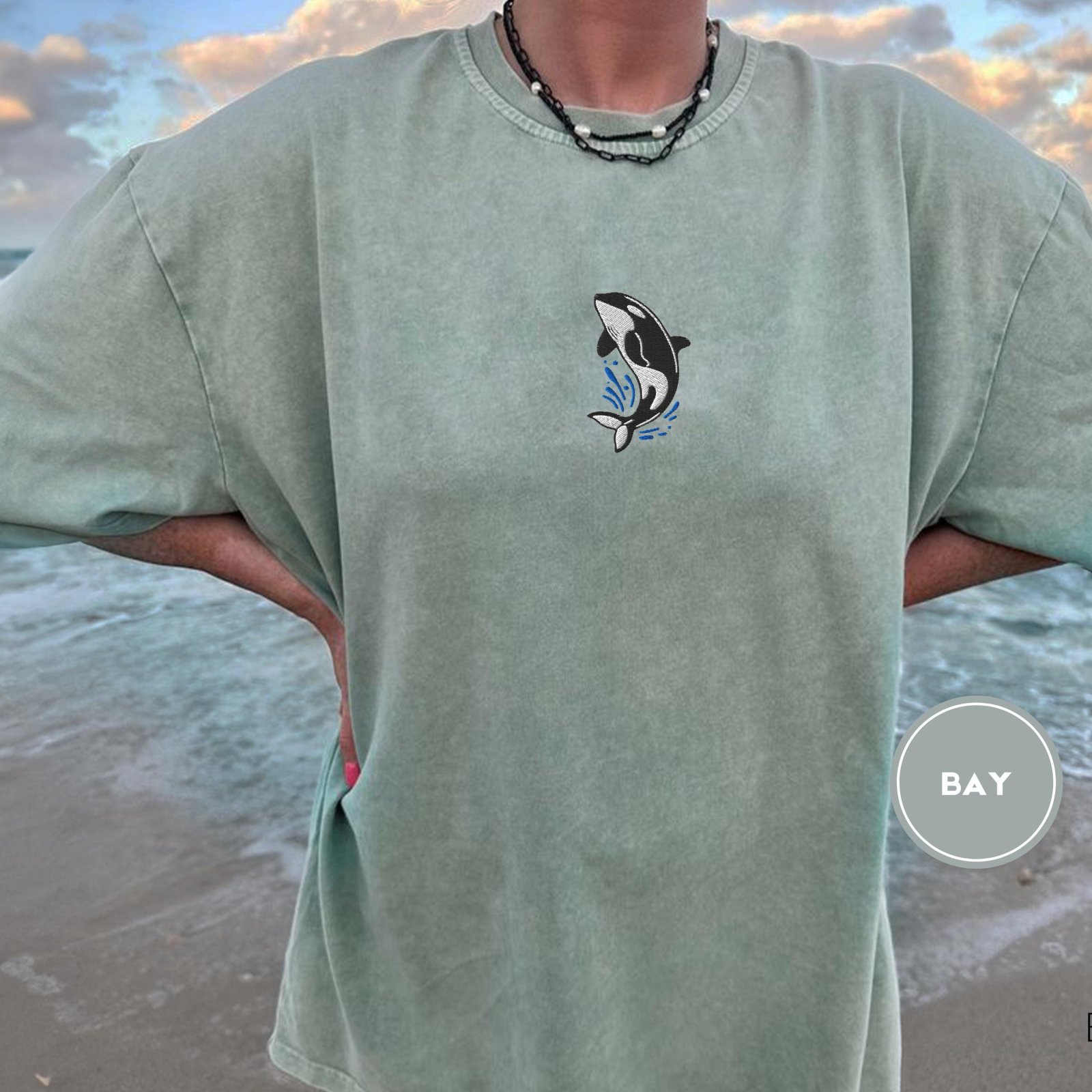 Person wearing a bay Orca Splash Embroidered T-Shirt
