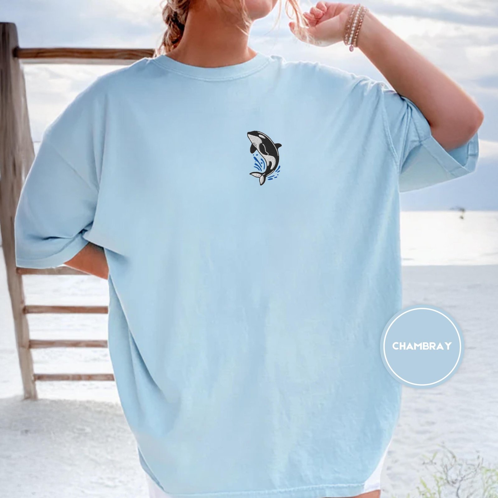 Person wearing a chambray Orca Splash Embroidered T-Shirt