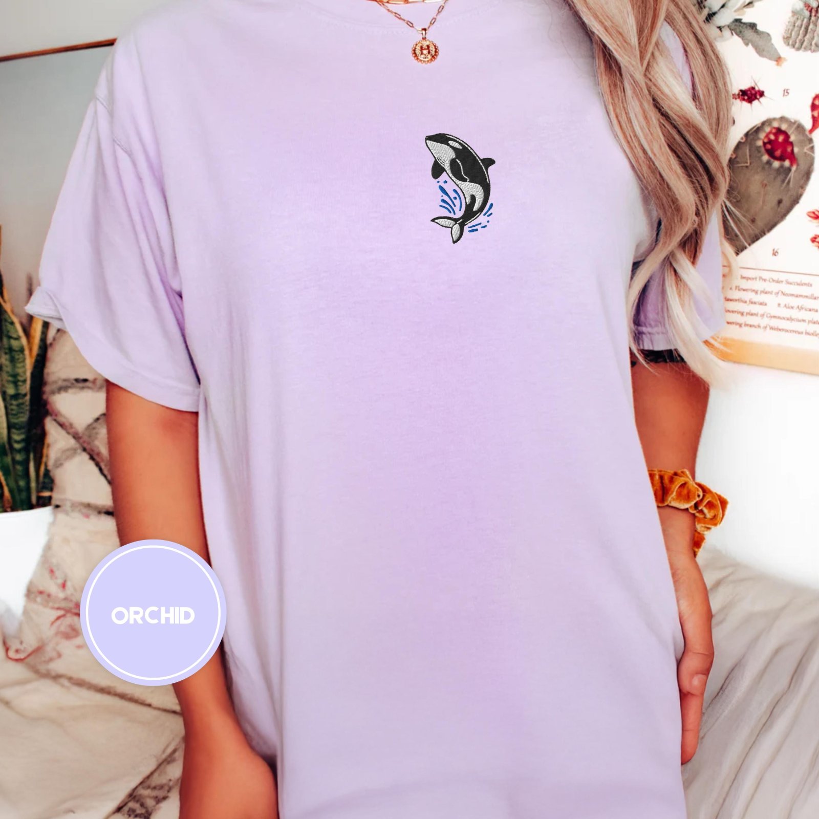 Person wearing an orchid Orca Splash Embroidered T-Shirt